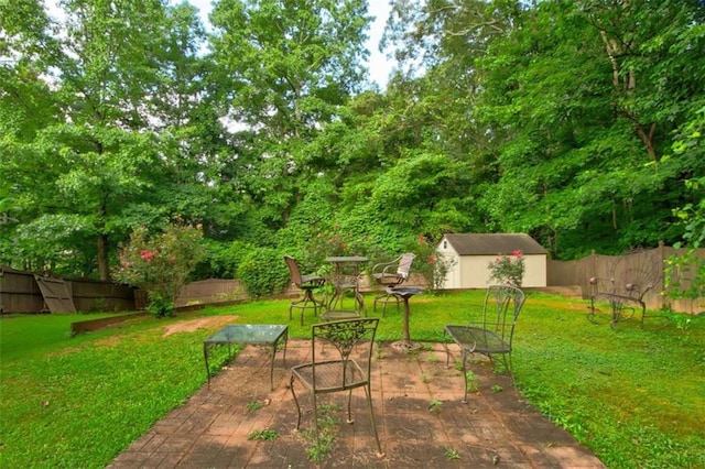 1137 Eagles Nest Cir, Carrollton, GA 30116 - fenced backyard featuring a shed and a patio area