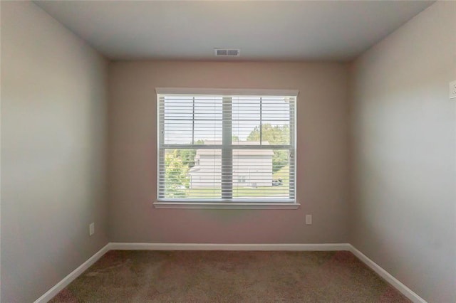 spare room with carpet floors and baseboards