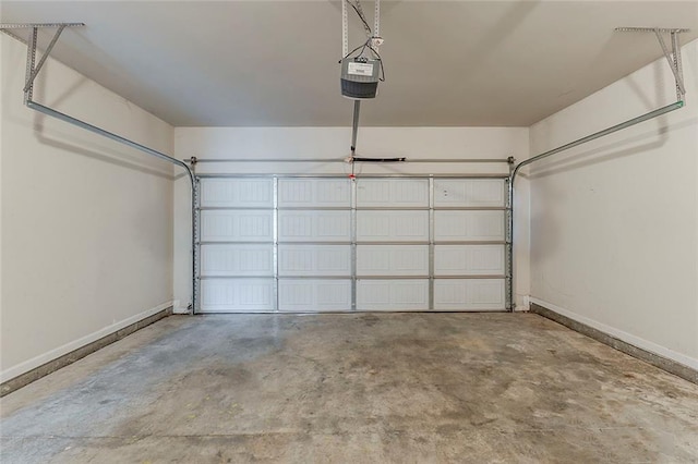 garage featuring baseboards and a garage door opener