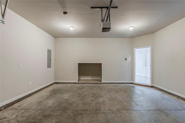 garage with electric panel, a garage door opener, and baseboards