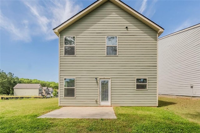 back of property with a patio and a yard