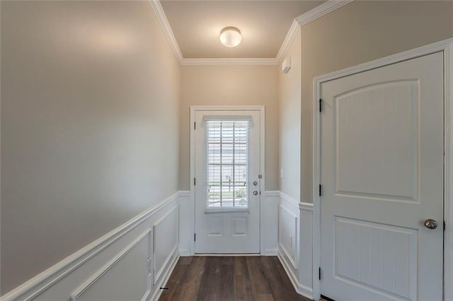doorway to outside featuring a wainscoted wall, crown molding, dark wood-type flooring, and a decorative wall