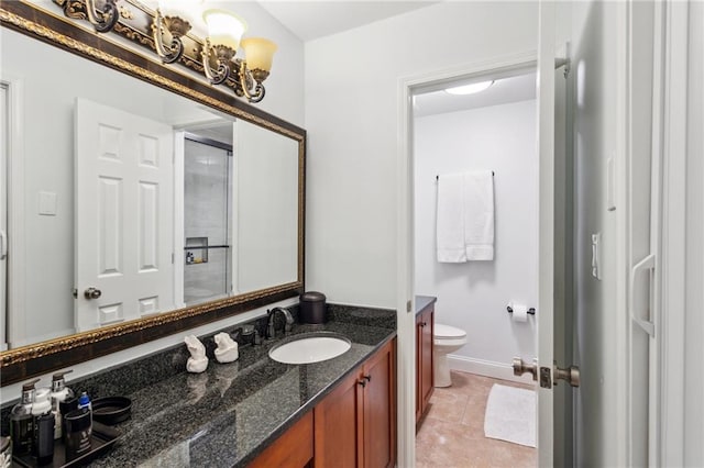 full bath with tile patterned flooring, baseboards, toilet, double vanity, and a sink