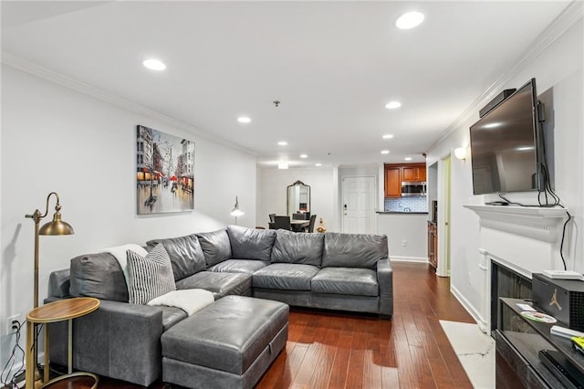 living room featuring crown molding, baseboards, a fireplace with flush hearth, recessed lighting, and dark wood-style floors