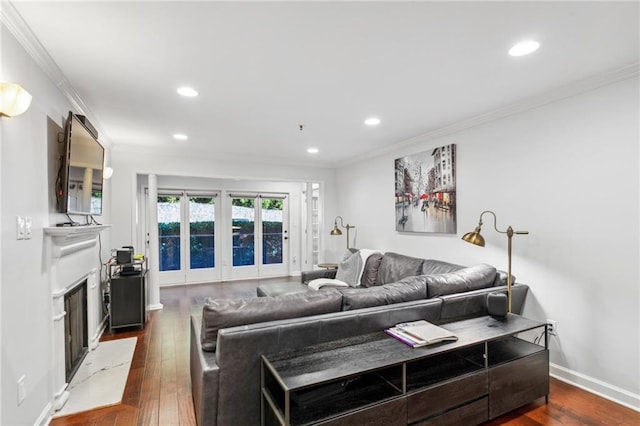 living room with a fireplace, recessed lighting, dark wood-style floors, and ornamental molding