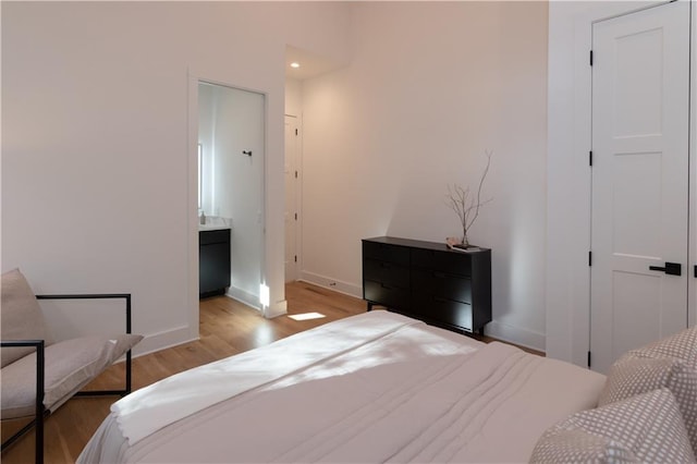 269 Clarice Ln, Sautee Nacoochee, GA 30571 - bedroom with ensuite bath, baseboards, and light wood finished floors