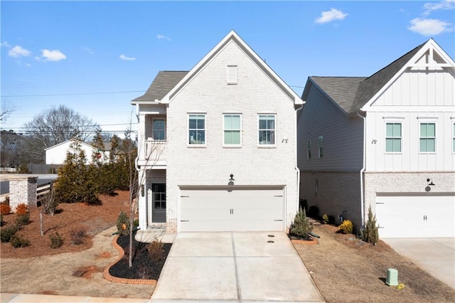 view of front of property with board and batten siding, a garage, concrete driveway, and brick siding