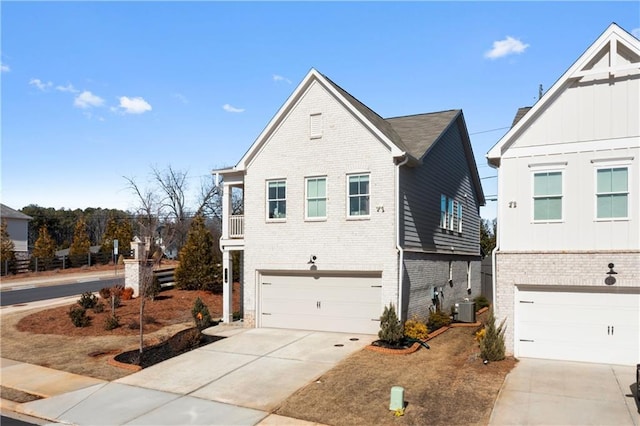 view of front facade featuring brick siding, driveway, central AC, and an attached garage