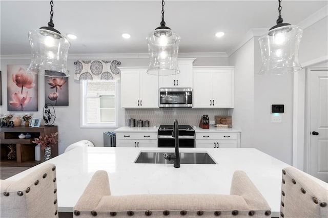 kitchen featuring ornamental molding, range, white cabinets, and decorative light fixtures