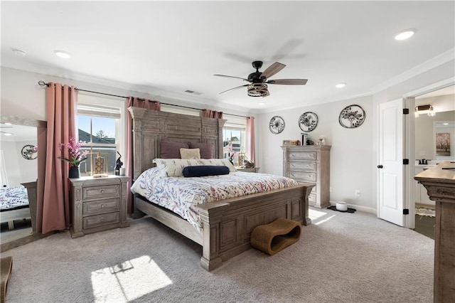 carpeted bedroom with ornamental molding and ceiling fan