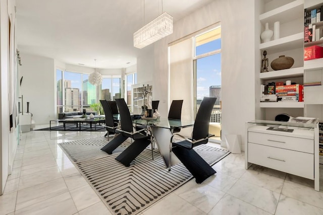 285 Centennial Olympic Park Dr NW Unit Ph2-7, Atlanta, GA 30313 - dining room featuring built in features, a view of skyline, light marble finish floors, and a chandelier