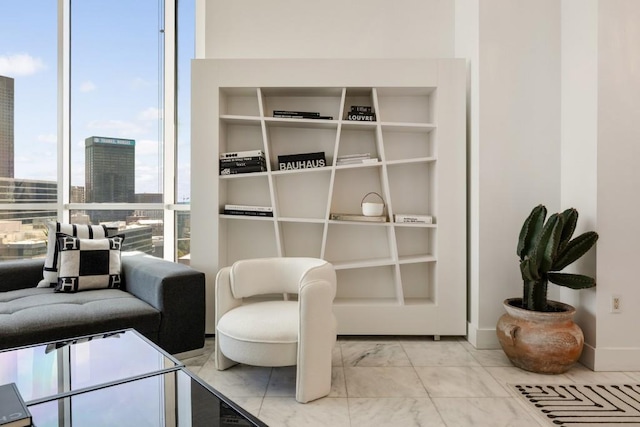 285 Centennial Olympic Park Dr NW Unit Ph2-7, Atlanta, GA 30313 - living area with marble look tile flooring and expansive windows