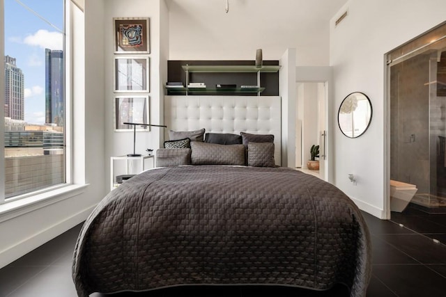 285 Centennial Olympic Park Dr NW Unit Ph2-7, Atlanta, GA 30313 - bedroom featuring multiple windows, dark tile patterned floors, a view of city, and baseboards