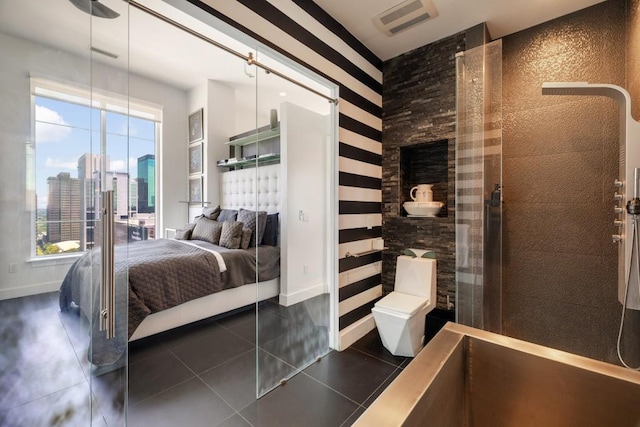 285 Centennial Olympic Park Dr NW Unit Ph2-7, Atlanta, GA 30313 - bedroom featuring a city view, multiple windows, and dark tile patterned flooring