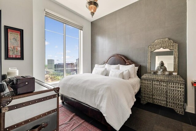 285 Centennial Olympic Park Dr NW Unit Ph2-7, Atlanta, GA 30313 - bedroom with multiple windows, tile walls, and a city view