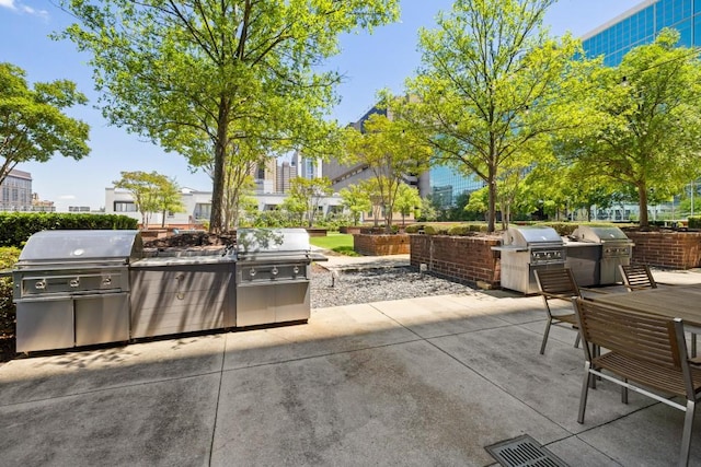 285 Centennial Olympic Park Dr NW Unit Ph2-7, Atlanta, GA 30313 - view of patio featuring an outdoor kitchen and a grill