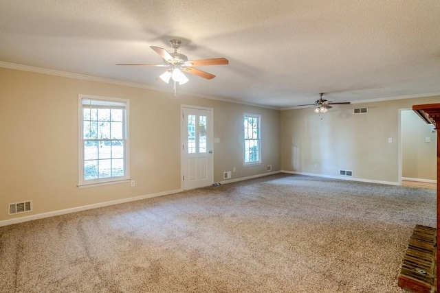 unfurnished room featuring a textured ceiling, carpet floors, and crown molding