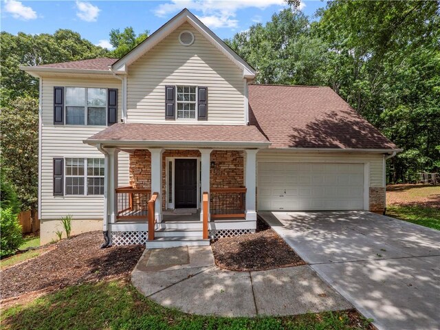 6333 Horizon Dr, Flowery Branch, GA 30542 - view of front of property with a garage, concrete driveway, stone siding, covered porch, and roof with shingles