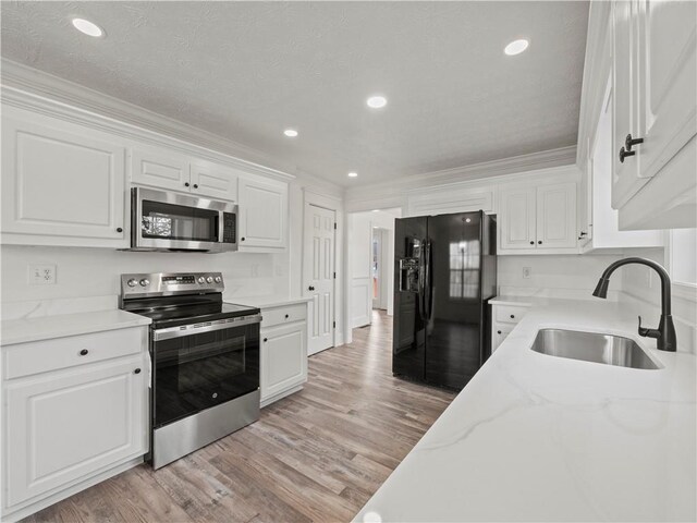 6333 Horizon Dr, Flowery Branch, GA 30542 - kitchen with black refrigerator with ice dispenser, dishwasher, a sink, light wood-style floors, and ornamental molding