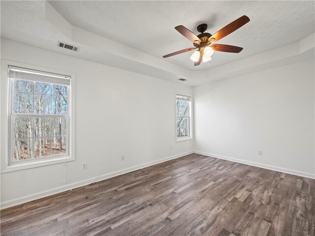 6333 Horizon Dr, Flowery Branch, GA 30542 - empty room with dark wood-style floors, baseboards, ceiling fan, and a tray ceiling