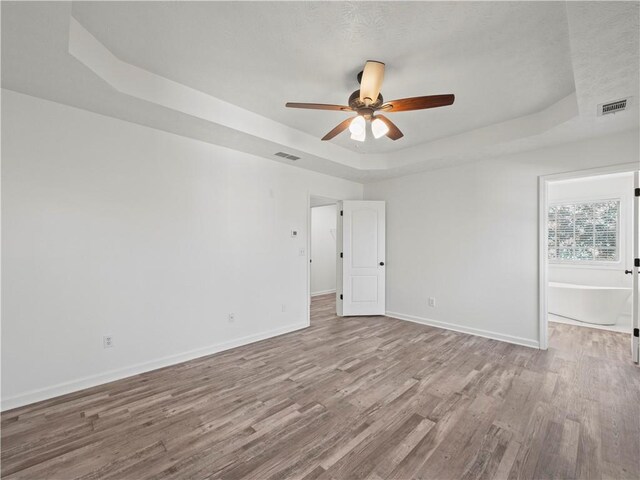 6333 Horizon Dr, Flowery Branch, GA 30542 - spare room featuring a raised ceiling, attic access, a ceiling fan, wood finished floors, and baseboards