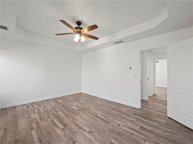 6333 Horizon Dr, Flowery Branch, GA 30542 - unfurnished room featuring a raised ceiling, attic access, a ceiling fan, wood finished floors, and baseboards