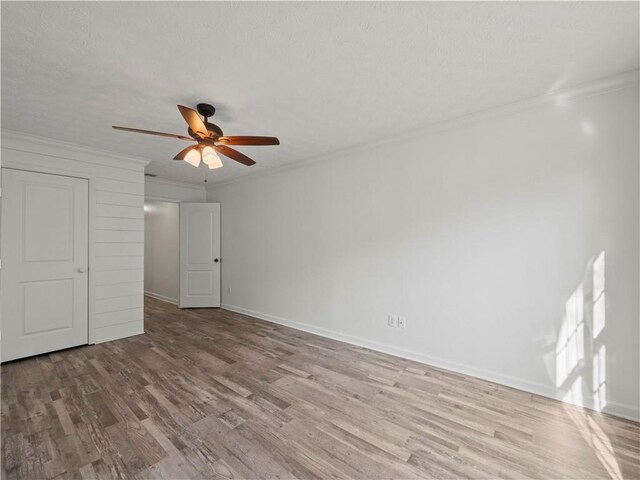 6333 Horizon Dr, Flowery Branch, GA 30542 - unfurnished bedroom with ornamental molding, wood finished floors, baseboards, and a ceiling fan