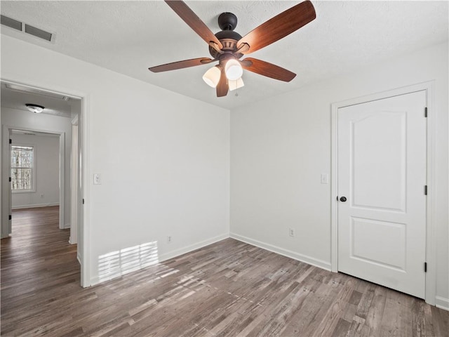 6333 Horizon Dr, Flowery Branch, GA 30542 - unfurnished room with wood finished floors, a ceiling fan, and baseboards