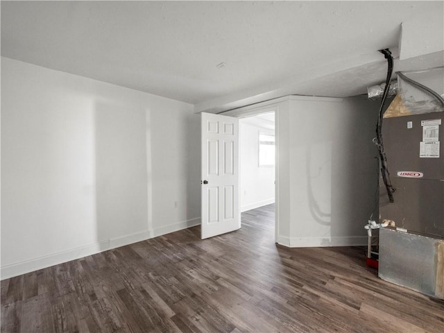 6333 Horizon Dr, Flowery Branch, GA 30542 - basement featuring wood finished floors, baseboards, and heating unit