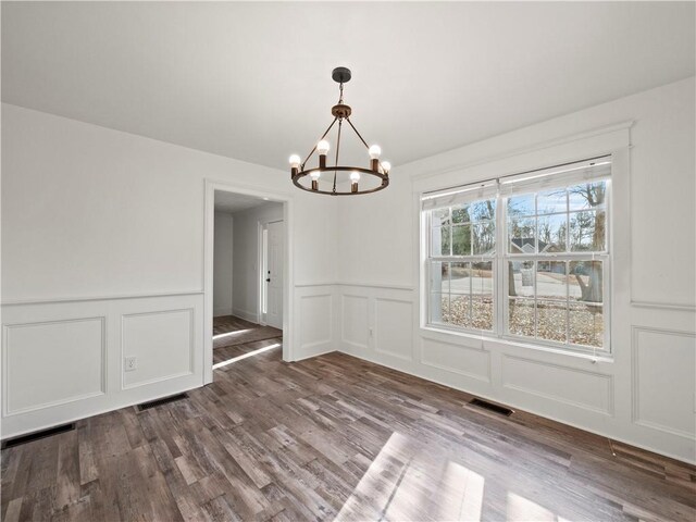 6333 Horizon Dr, Flowery Branch, GA 30542 - spare room with a chandelier, a decorative wall, wood finished floors, and a wainscoted wall