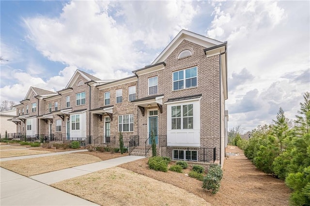 townhome / multi-family property featuring brick siding