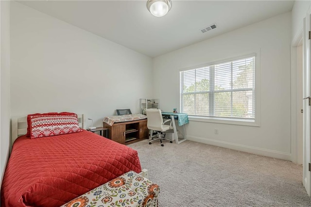 carpeted bedroom with visible vents and baseboards