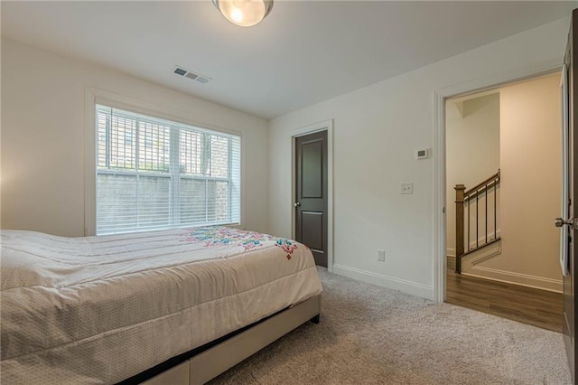 bedroom featuring baseboards, visible vents, and carpet floors