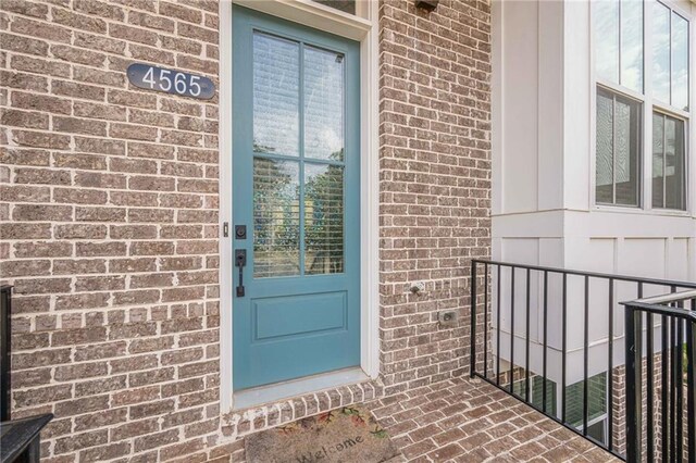 property entrance featuring brick siding