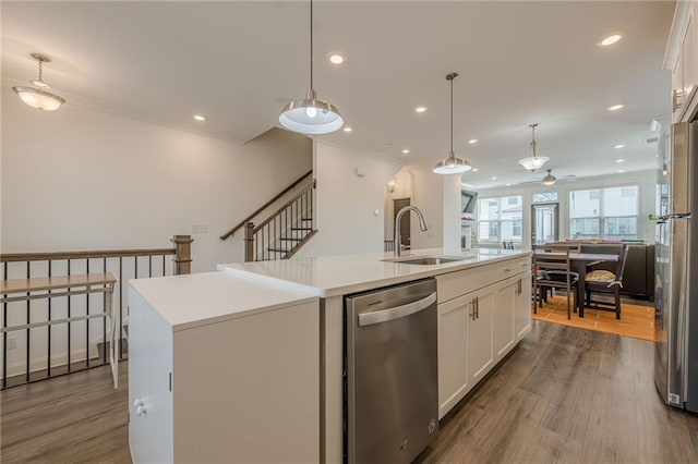 kitchen with a sink, ceiling fan, dark wood-type flooring, white cabinets, and stainless steel appliances