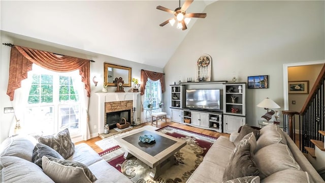 9742 Fallview Ct, Villa Rica, GA 30180 - living room with high vaulted ceiling, ceiling fan, a stone fireplace, wood finished floors, and stairs