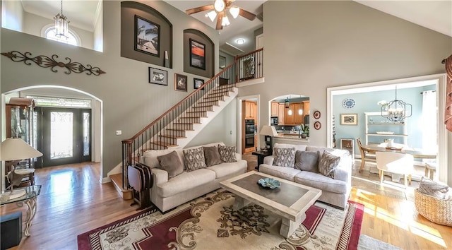 9742 Fallview Ct, Villa Rica, GA 30180 - living room with a towering ceiling, healthy amount of natural light, stairway, a chandelier, and wood finished floors