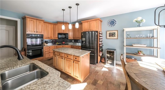 9742 Fallview Ct, Villa Rica, GA 30180 - kitchen featuring black appliances, a sink, tasteful backsplash, light stone countertops, and hanging light fixtures