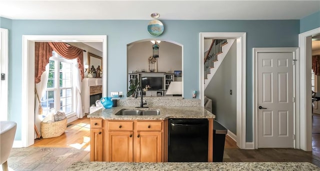 9742 Fallview Ct, Villa Rica, GA 30180 - kitchen with a sink, dishwasher, light stone countertops, light brown cabinetry, and baseboards