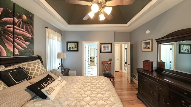 9742 Fallview Ct, Villa Rica, GA 30180 - bedroom with a tray ceiling, light wood finished floors, and ceiling fan