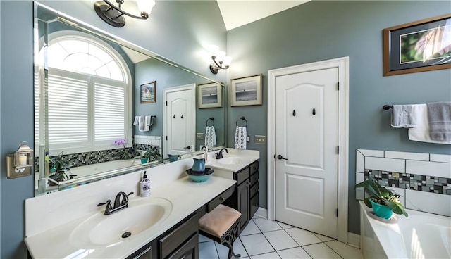 9742 Fallview Ct, Villa Rica, GA 30180 - bathroom featuring a garden tub, double vanity, tile patterned floors, and baseboards