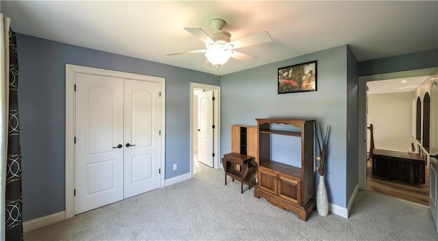 9742 Fallview Ct, Villa Rica, GA 30180 - bedroom featuring light colored carpet, a closet, baseboards, and a ceiling fan