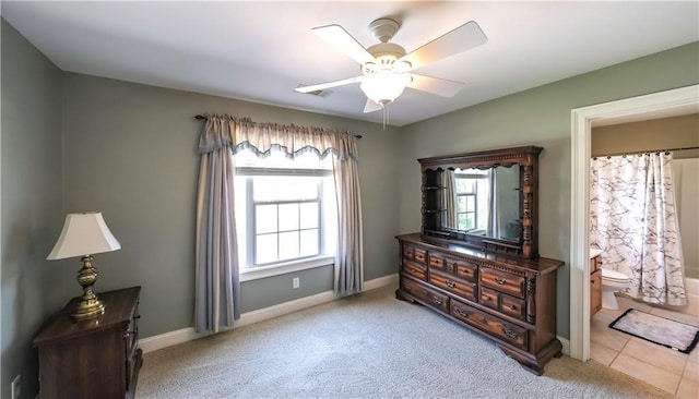 9742 Fallview Ct, Villa Rica, GA 30180 - bedroom featuring baseboards, light carpet, connected bathroom, and ceiling fan
