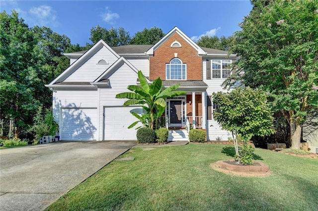 view of front of house with a front yard, brick siding, driveway, and an attached garage