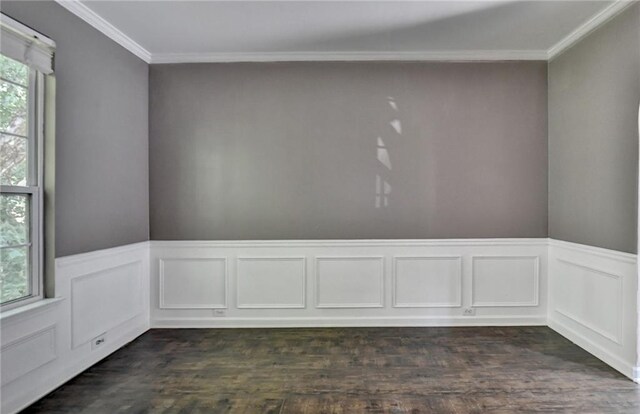 spare room featuring dark hardwood / wood-style floors and crown molding