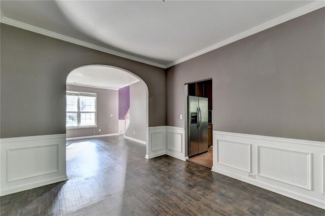 empty room with ornamental molding and wood-type flooring