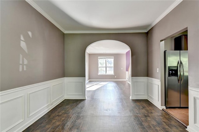 empty room featuring dark hardwood / wood-style floors and ornamental molding