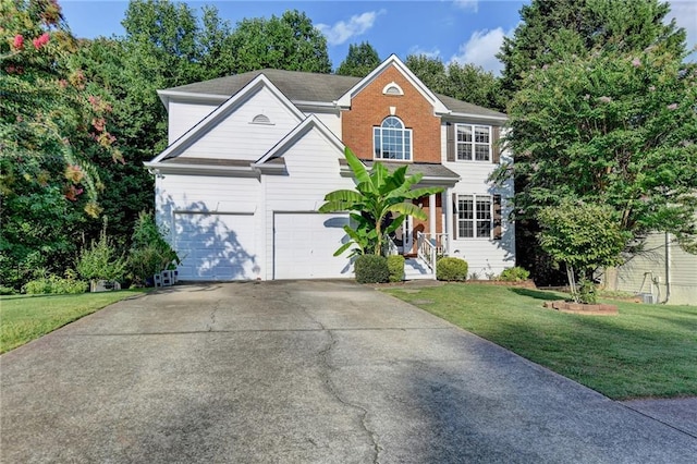 view of front of home featuring a front yard, brick siding, driveway, and an attached garage