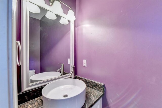 bathroom featuring toilet and vanity