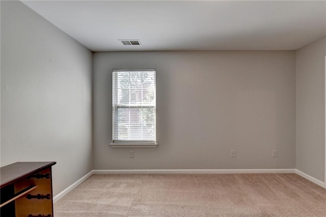 empty room with light carpet, baseboards, and visible vents